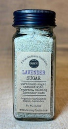 a glass jar filled with organic lavender sugar and dried lavender buds for culinary use.